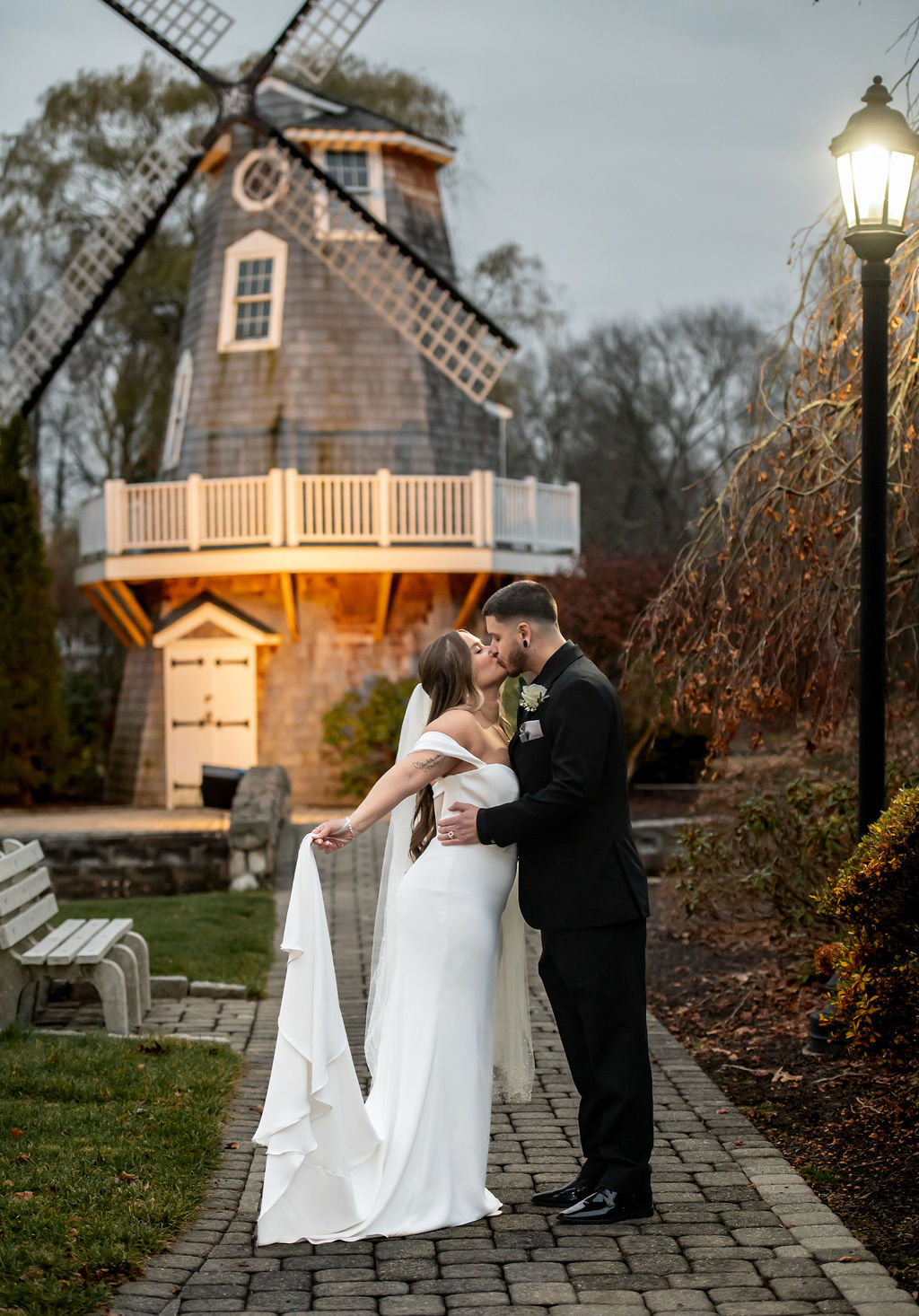 Couple sharing a kiss at the Aqua Turf in front of the windmill