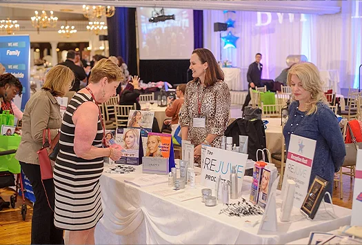 Women gather around a table at a seminar