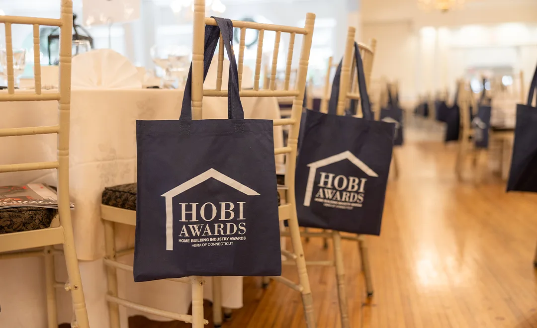 Bags hanging on chairs at an event