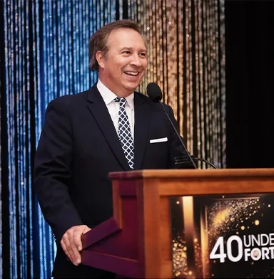 Man speaking from podium at a corporate event