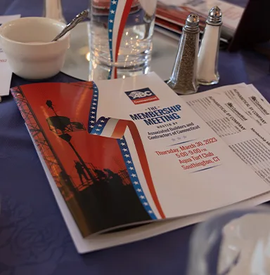 Meeting agenda and documents on table at an event