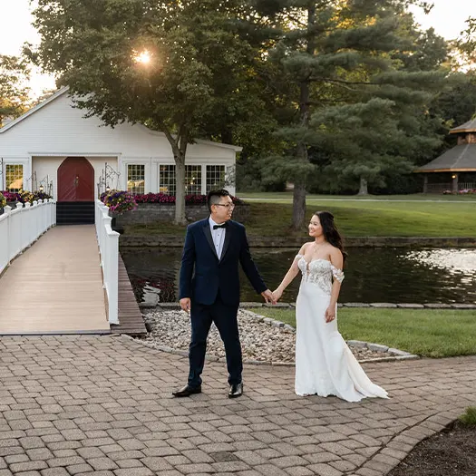 Newlyweds walking outside of the Glass Room