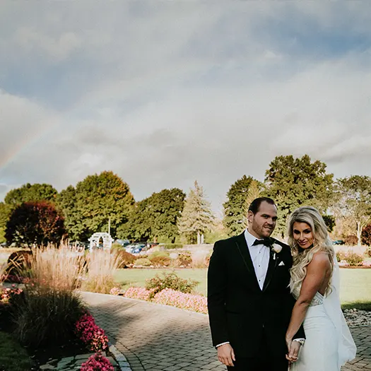 Bride and groom posing outside