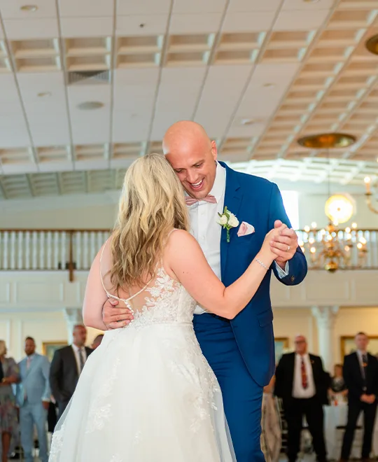 Bride and groom smiling while dancing