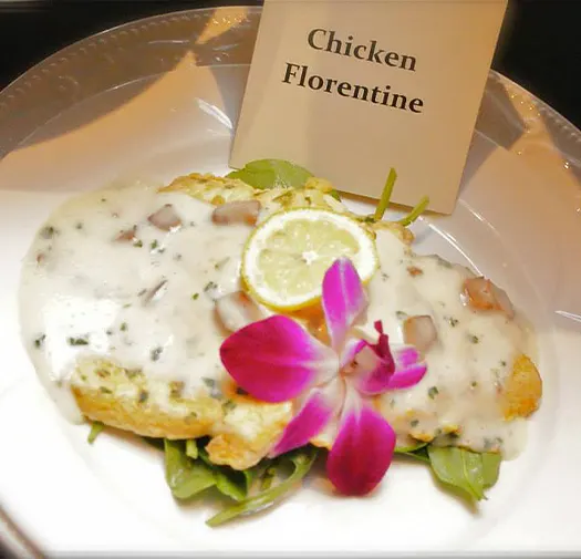 Chicken Florentine with flower garnish on a plate
