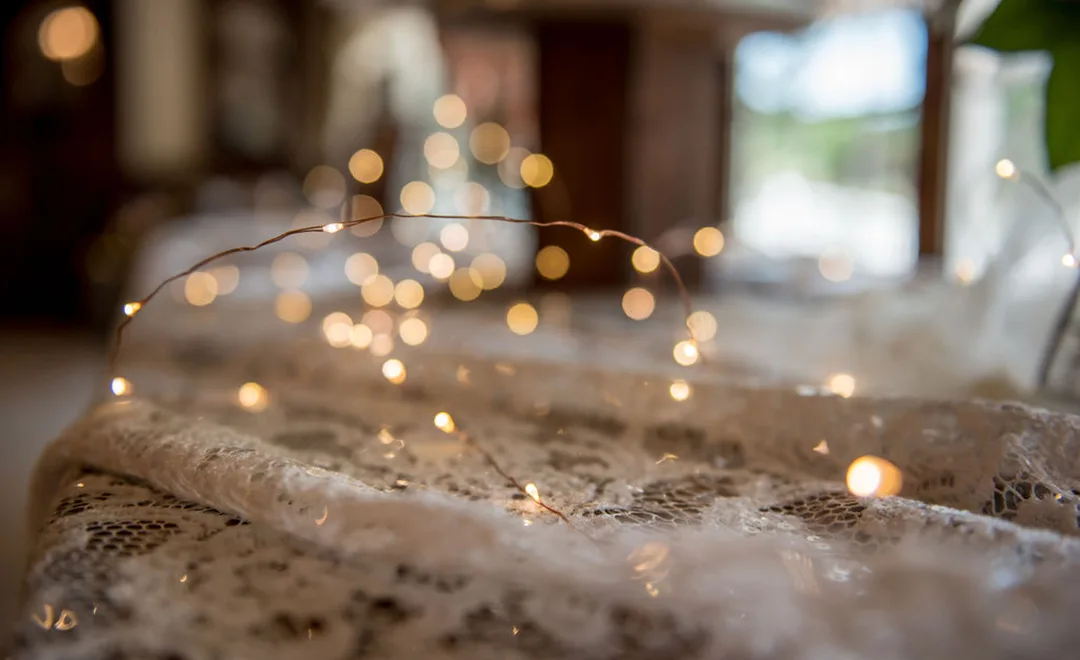 Lace doily and LED lights adorn a table in the Wagon Room