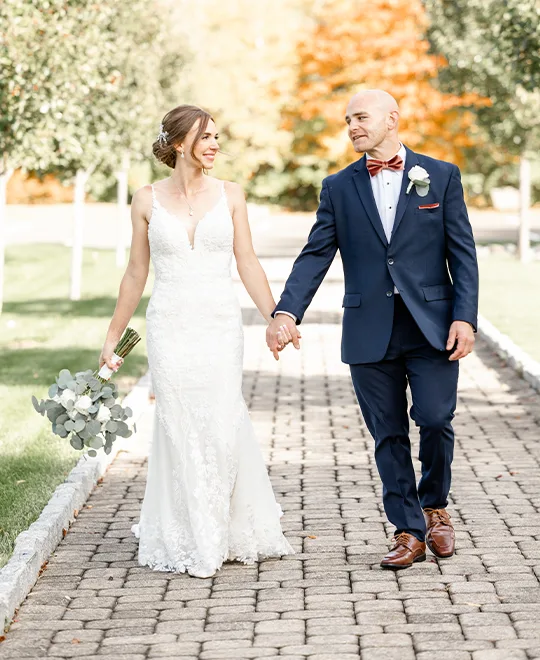 Bride holding bouquet of flowers and groom's hand