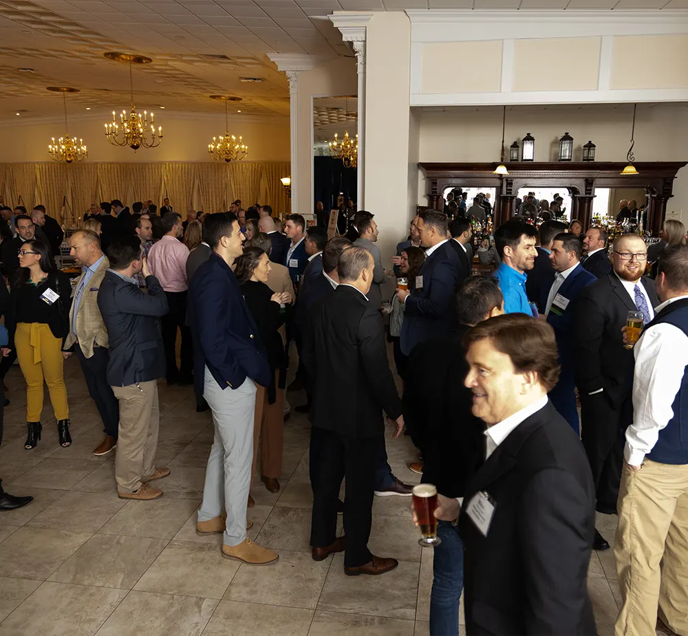 Guests mingle by the bar whilst attending a corporate event