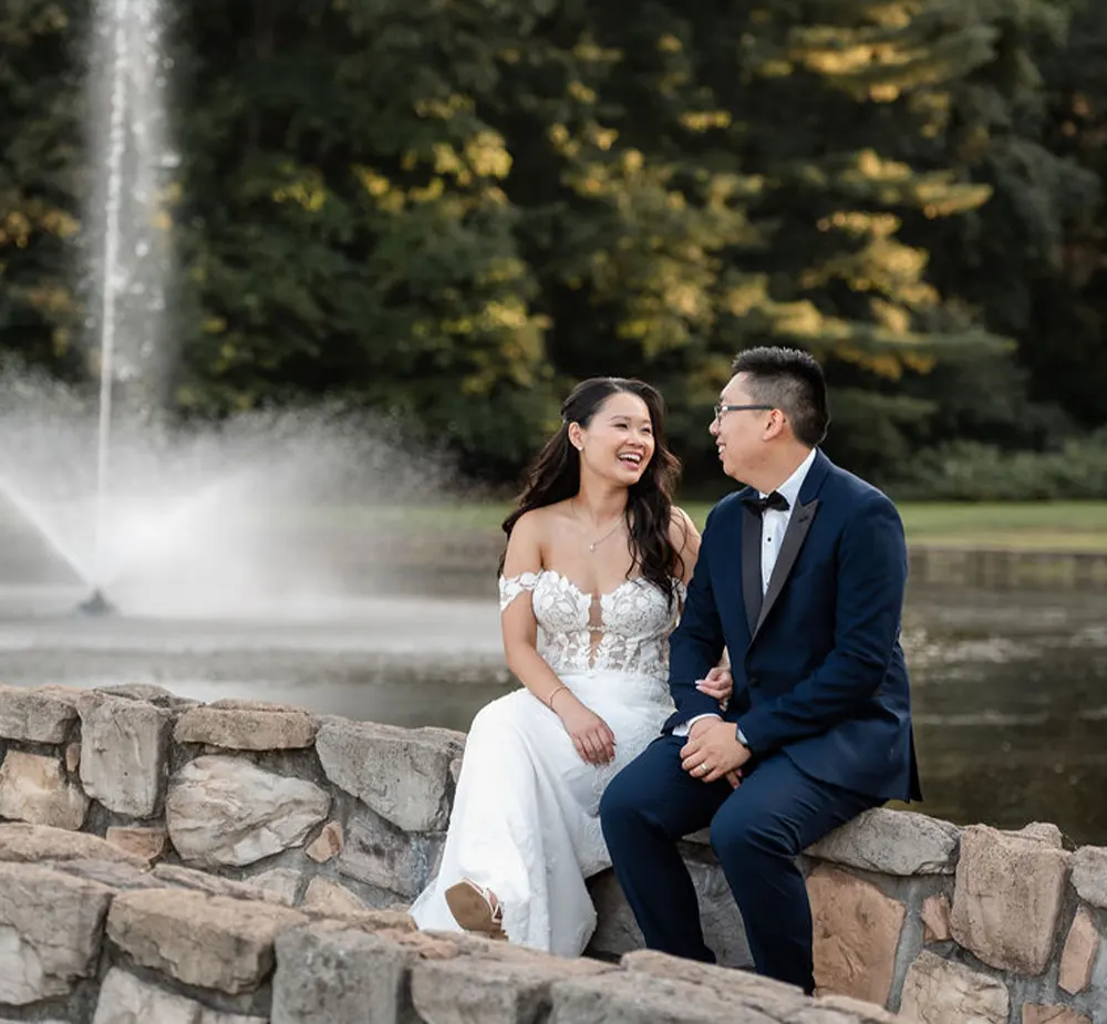 Bride and groom laugh while gazing into each others eyes